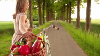 woman-in-park-with-bicycle-and-basket-of-vegetables_rgdp2bswg_thumbnail-full01