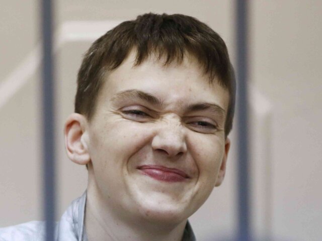 Ukrainian military pilot Nadezhda Savchenko reacts inside a defendant’s cage during a court he