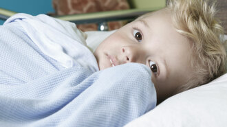 47206937 — a sick little boy in a hospital bed