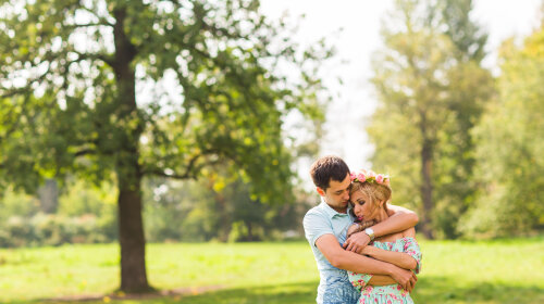 beautiful young couple hugging in the park