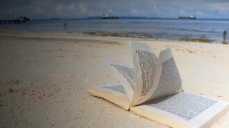 cropped-reading-books-literature-beach-holiday-candid-people-boats-photo