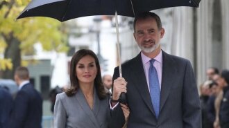 В сером платье под зонтом: королева Летиция с королем Филиппом VI посетили мероприятие в Мадриде