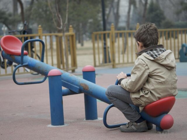 lone-child-on-playground-equipment