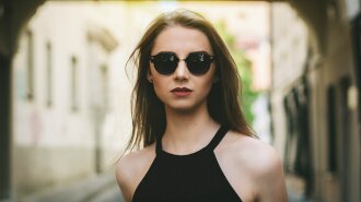 woman_looking_forward_in_sunglasses_and_a_black_halter_top