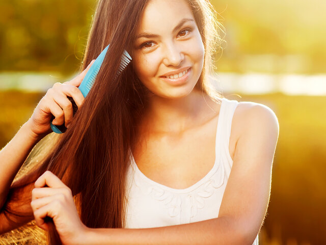 beautiful girl combs her hair Asian appearance