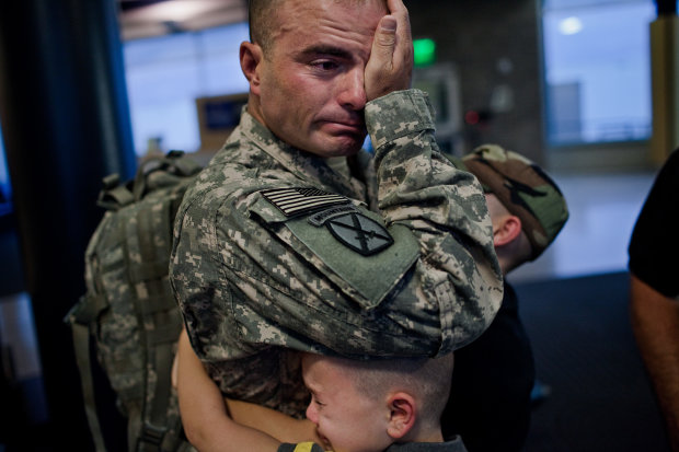 Sergeant First Class Brian Eisch weeps, as he struggles to say goodbye to his children.