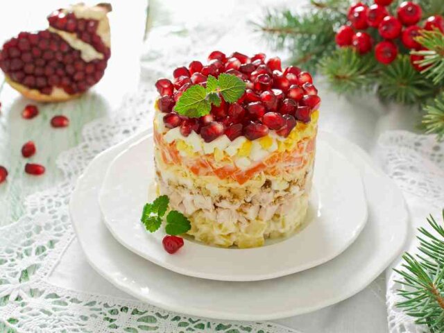 Layered salad from vegetables on the holiday table