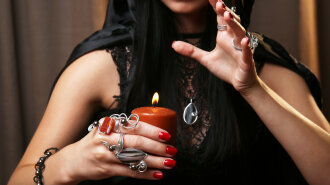 Witch — fortune teller on dark background