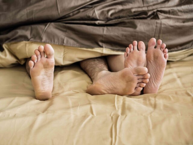 Caucasian couple lying on bed together