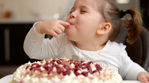 Cute little girl eating cake