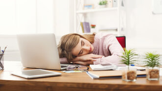 Sleeping overworking business woman at office