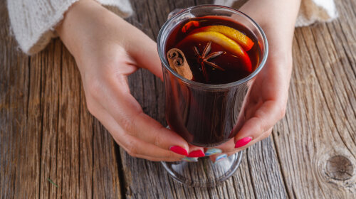 Mulled wine and spices on weathered wooden table