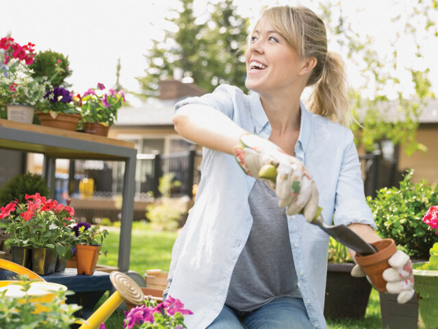 complements_smiling-woman-planting-flowers-in-garden_masterfile-69-web