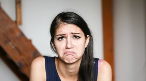 Beautiful brunette young woman with sad face. Sad expression, sa