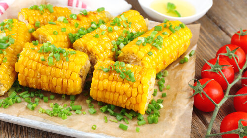 Grilled corn cobs on table, close-up