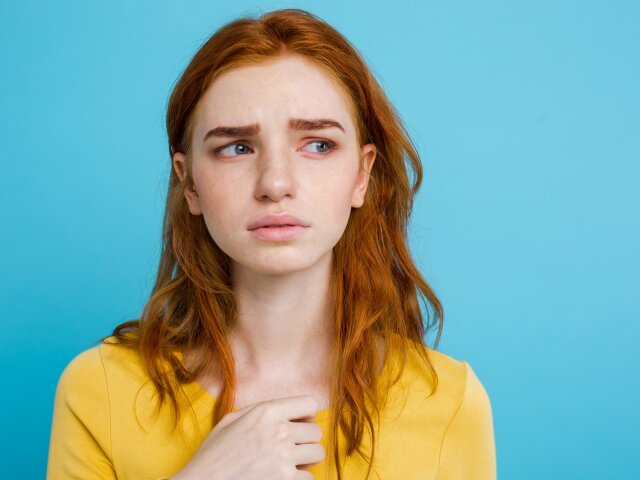 Headshot Portrait of tender redhead teenage girl with serious ex