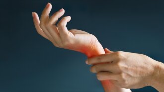 Acute pain in a woman wrist, colored in red on dark blue backgro