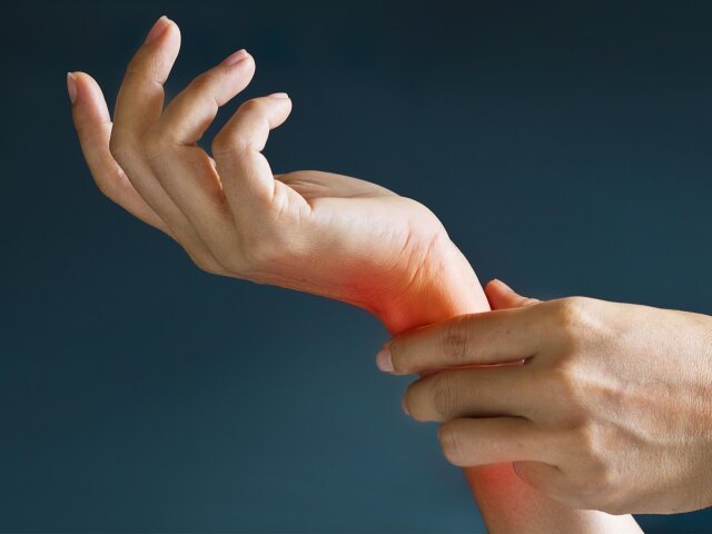 Acute pain in a woman wrist, colored in red on dark blue backgro