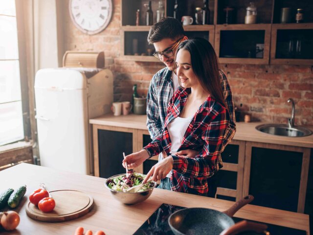 Love couple cooking on kitchen, salad preparation