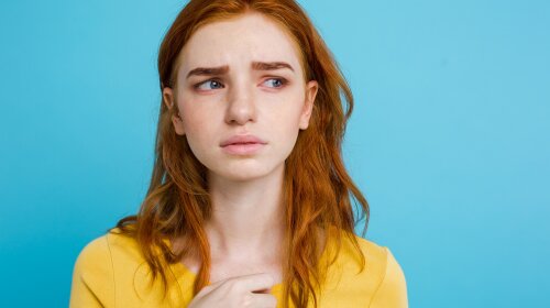 Headshot Portrait of tender redhead teenage girl with ex serious