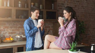 Couple drinking coffee in their loft kitchen