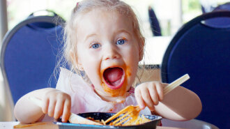 37919969 — funny little blond girl eating and pasta making a mess