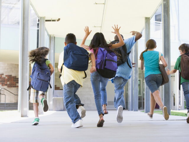 Elementary school pupils running outside