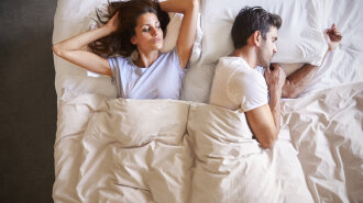 Overhead View Couple Of Relationship With Problems Lying In Bed