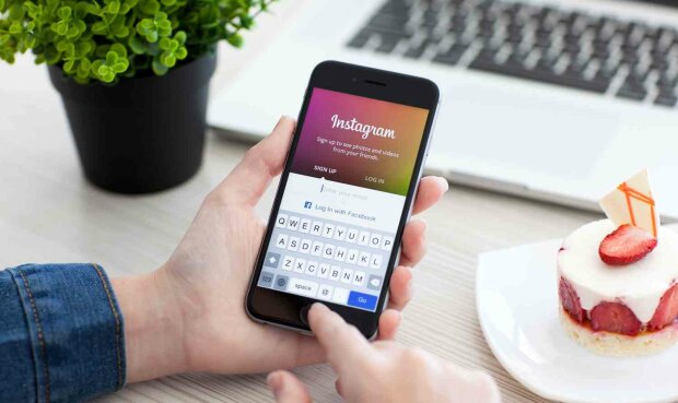 Woman holding iPhone 6 Space Gray with service Instagram