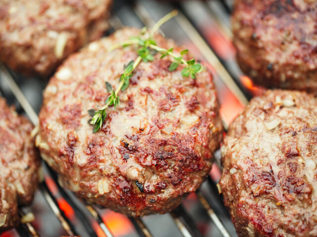 food meat — beef burgers on bbq barbecue with grill flame