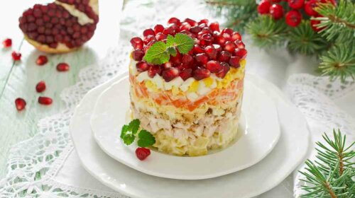 Layered salad from vegetables on the holiday table