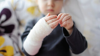 Little girl showing her hand bandaged